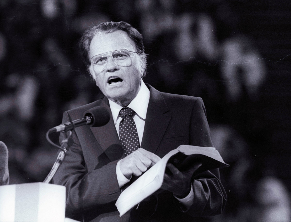 FILE PHOTO: Evangelist Graham, preaches the Gospel to thousands of believers during the meeting at Bercy's Stadium in Paris as part of a worldwide crusade